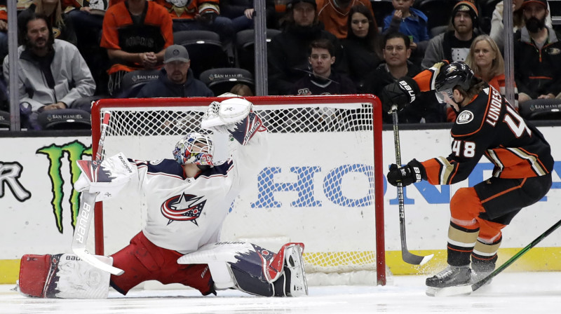 Elvis Merzļikins efektīgā veidā atvaira Anaheimas "Ducks" metienu. Foto: Marcio Jose Sanchez/AP/Scanpix