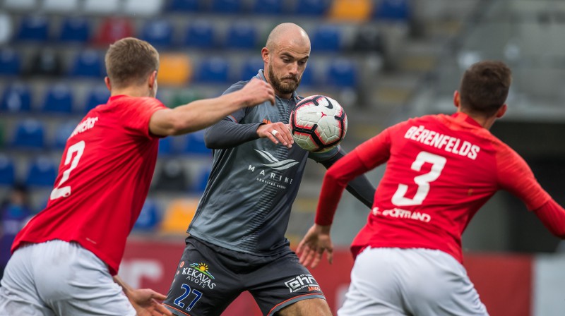 "Spartaka" aizsargi Klāvs Kramēns un Ņikita Bērenfelds pret "Riga" uzbrucēju Romanu Debelku. Foto: Zigismunds Zālmanis/rigafc.lv